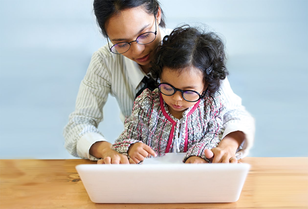 woman with small child looking at computer